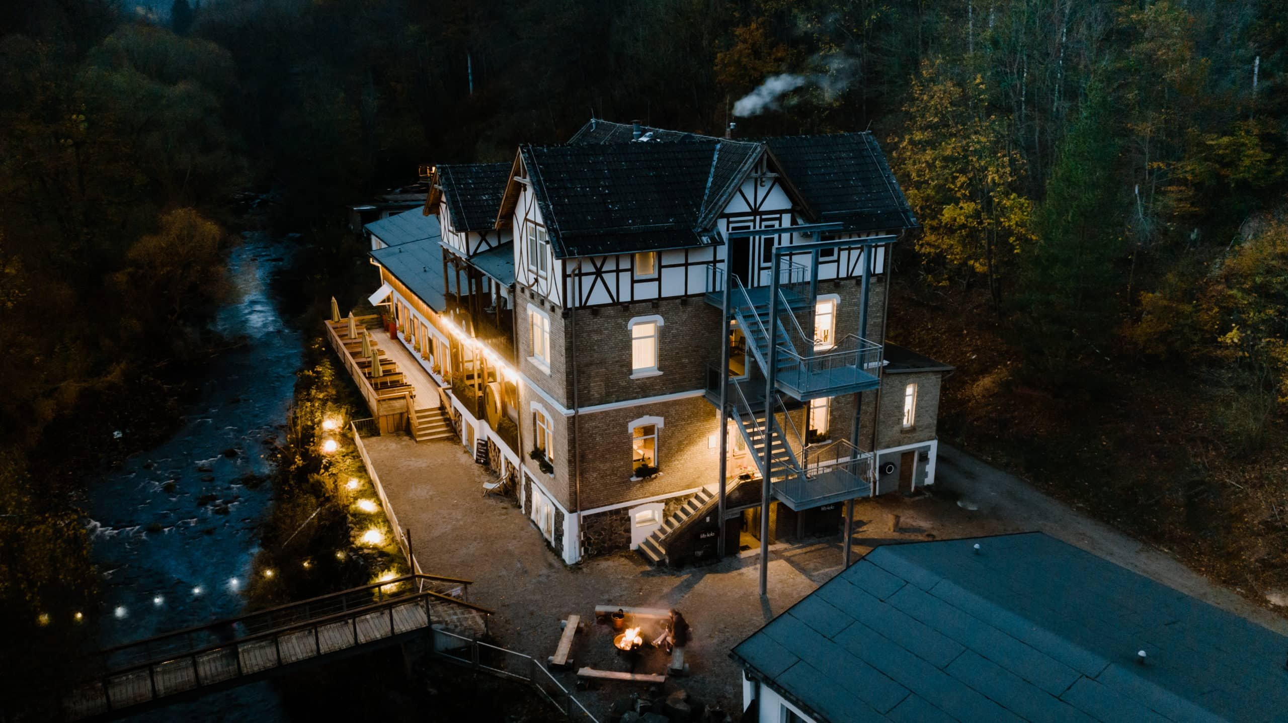 Fachwerkhaus mit Lichterketten am Abend in Harzlandschaft